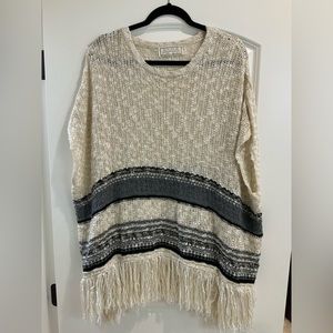Sinuous Small Sweater Poncho with Fringe Detail